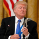 Image of Trump inspecting a big tool via AP.
